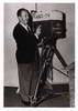 Posing next to an ABC camera, 1950s
